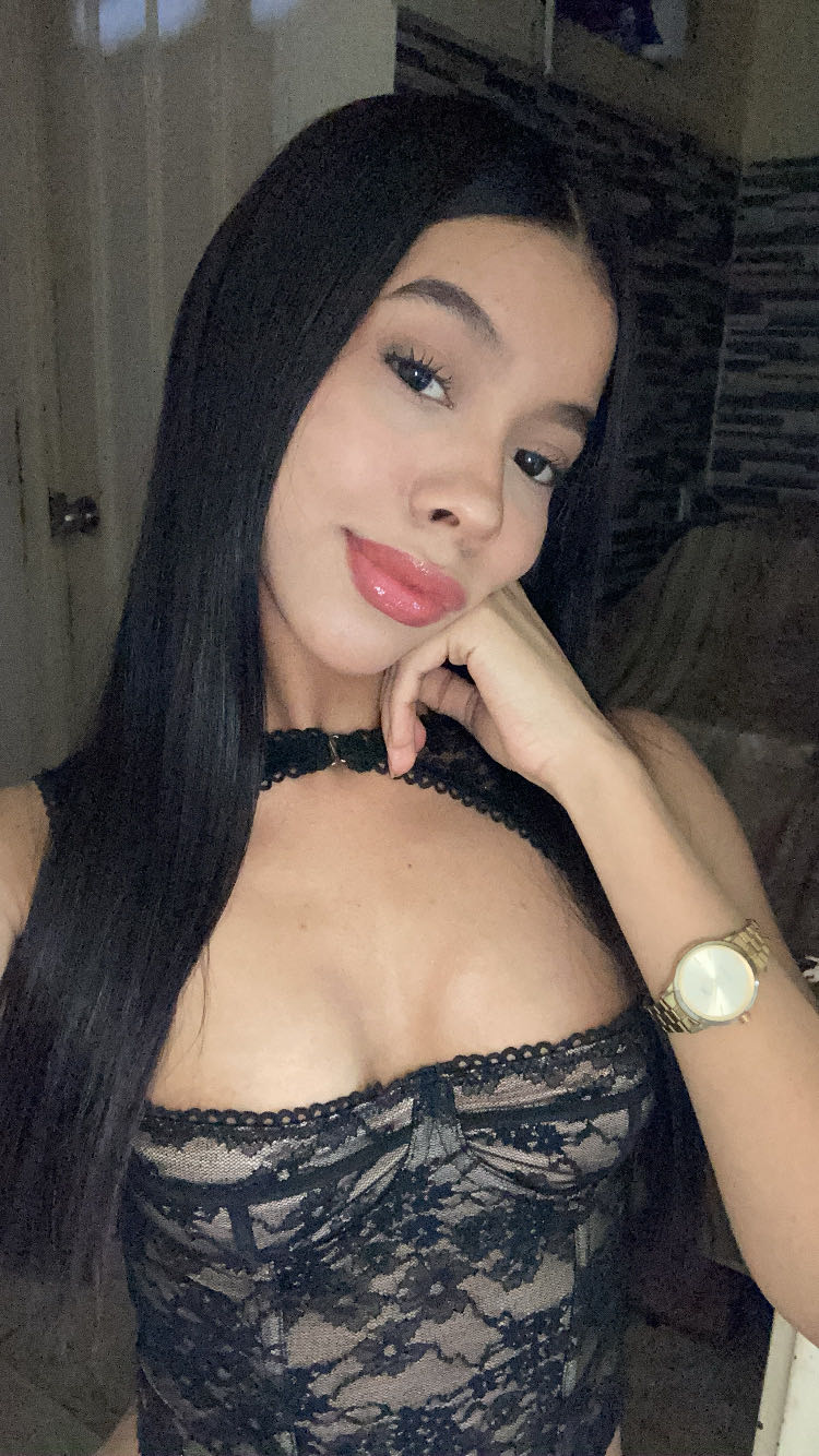 Woman with long black hair resting her chin on her hand
