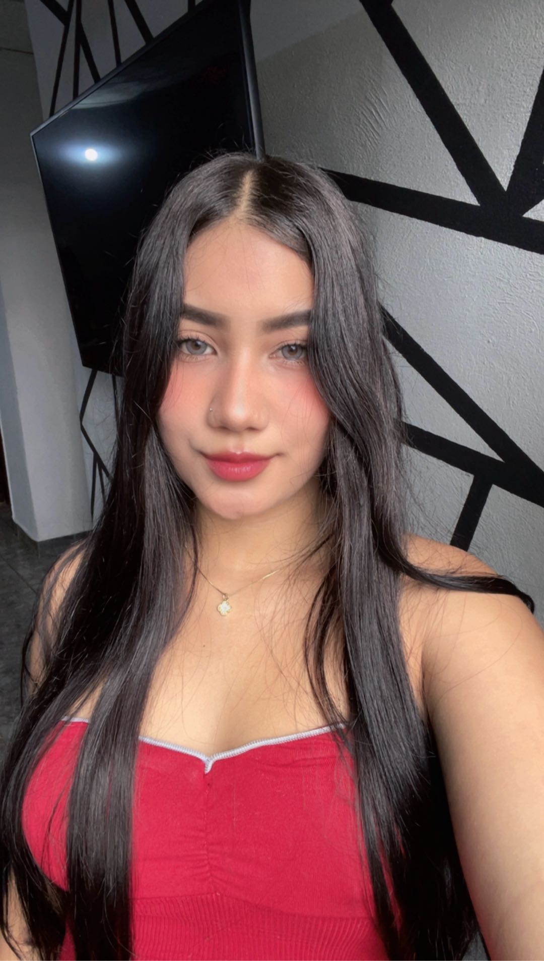 Woman with long dark hair in a red top