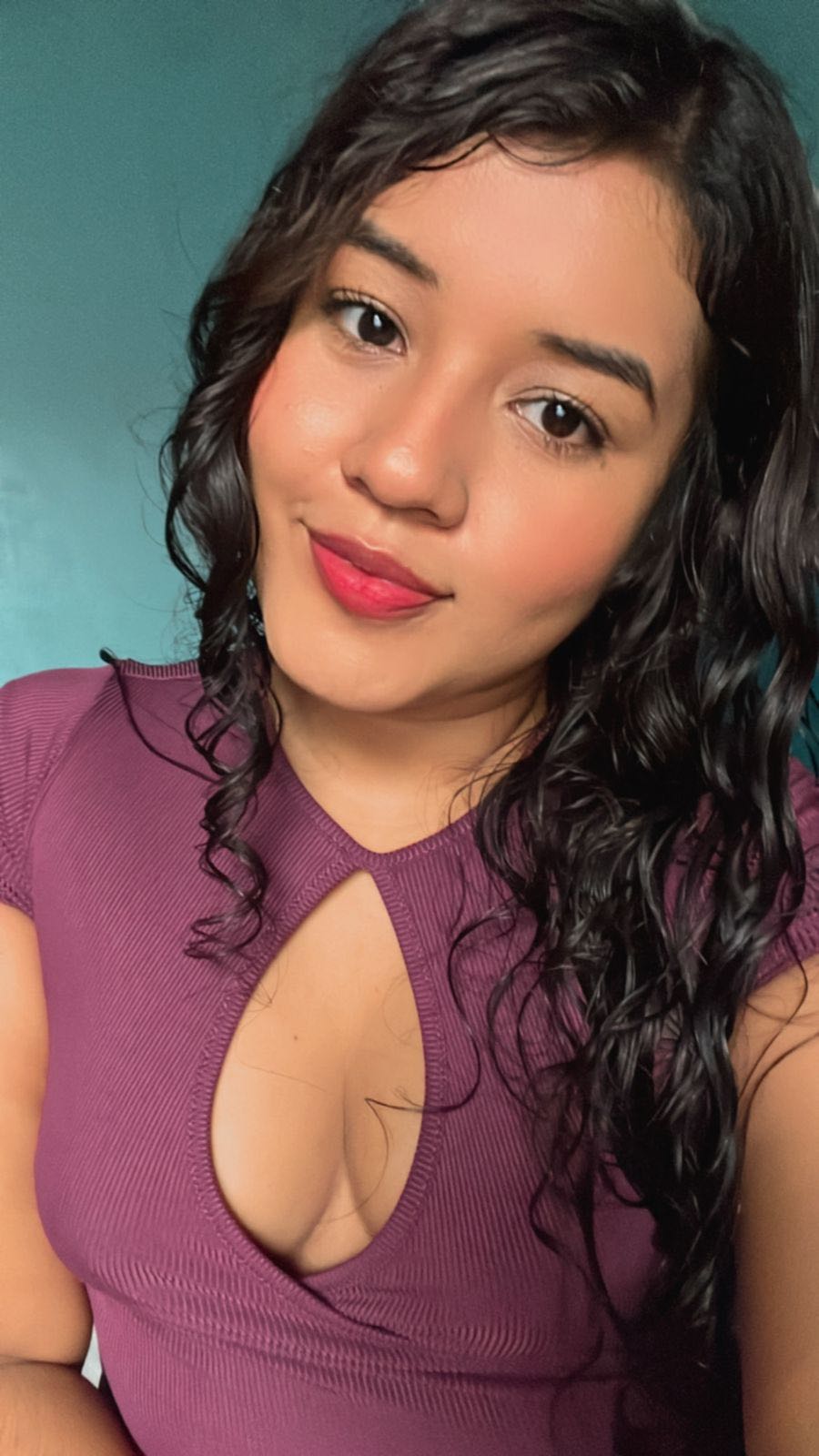 Woman with curly dark hair smiling