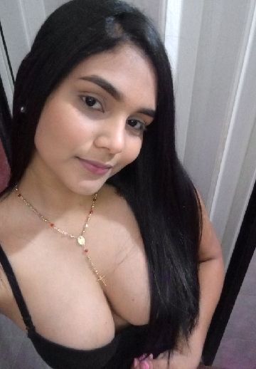 Woman with long black hair and a soft smile