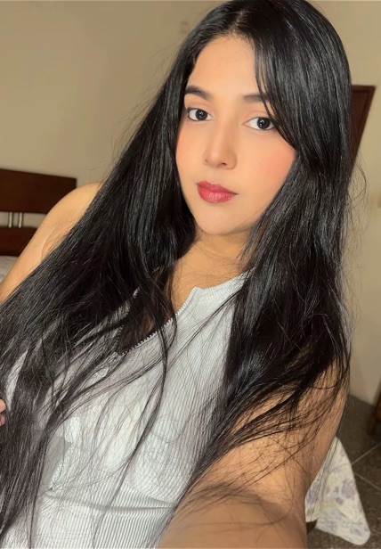 Woman with long dark hair smiling in a light top