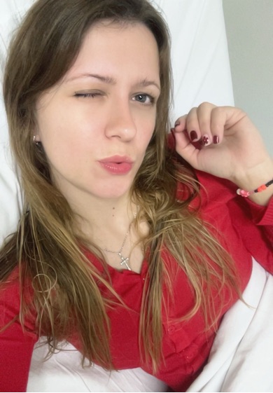 Woman with light brown hair winking at the camera