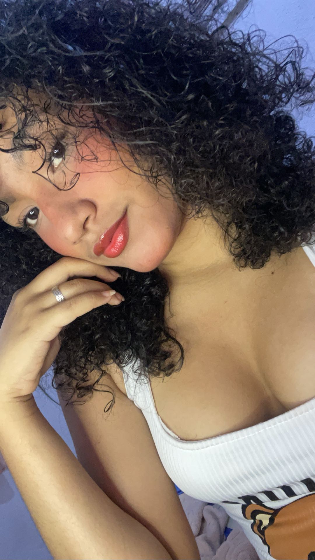 Woman with curly hair smiling while lying back
